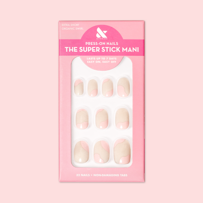 Organic Swirl | Extra Short | Round - Tab Press-On showing neutral nails with light pink swirls in packaging on soft pink background