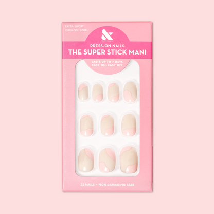 Organic Swirl | Extra Short | Round - Tab Press-On showing neutral nails with light pink swirls in packaging on soft pink background