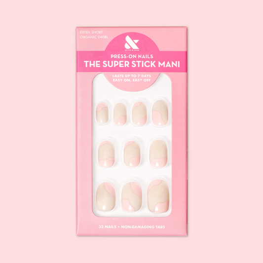 Organic Swirl | Extra Short | Round - Tab Press-On showing neutral nails with light pink swirls in packaging on soft pink background