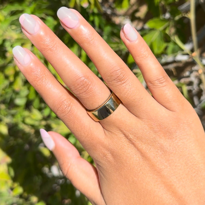 Organic Swirl | Extra Short | Round - Tab Press-On showcasing light pink swirl mani on natural nails outdoors in sunlight