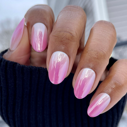 Pink Chrome Gradient | Medium | Oval - Tab Press-On nails with soft pink and white gradient in medium oval shape on hand outdoors