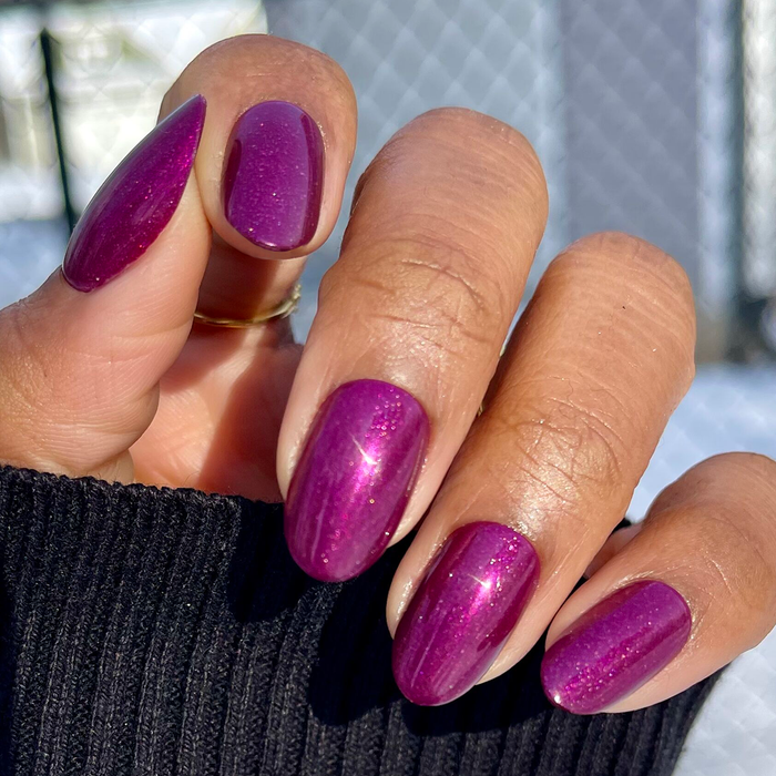Plaza Shimmer | Medium | Oval - Tab Press-On nails in sparkling deep mulberry purple on medium oval shaped nails outdoors