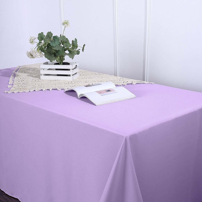 Purple tablecloth draped over a table with a decorative centerpiece.
