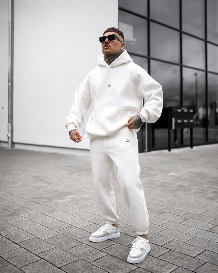 Martin Valen Regalia Crown oversized white hoodie and joggers, low-angle view with hood up and small crown logo