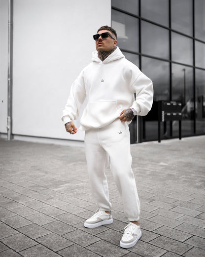 Martin Valen Regalia Crown oversized white hoodie and joggers, low-angle view with hood up and small crown logo