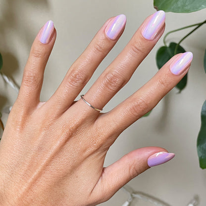 Hand with Rose Chrome - Press-On | Medium | Almond false nails in glossy pink chrome finish against neutral background