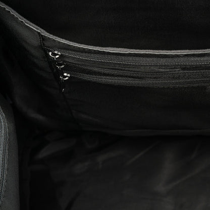 Black bag interior showing two zippered pockets and fabric lining