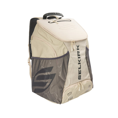 Beige and gray SELKIRK backpack with zip pockets, mesh side pocket and top handle
