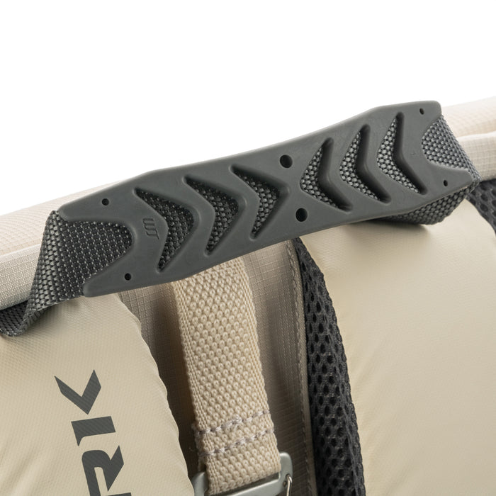 Padded molded rubber top handle and adjacent beige shoulder strap with mesh backing on a backpack.
