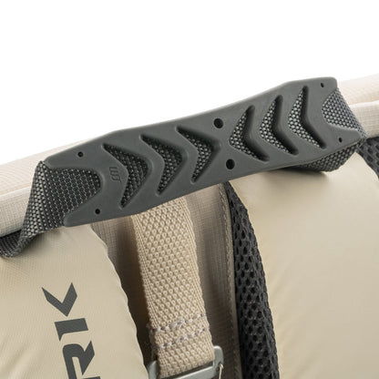 Padded molded rubber top handle and adjacent beige shoulder strap with mesh backing on a backpack.
