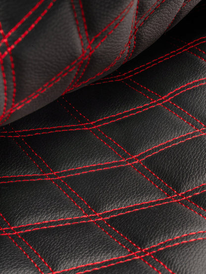 Close-up of black leather with red diamond-quilt stitching