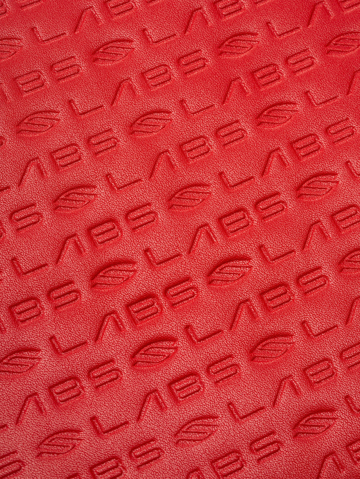 Red textured material embossed with repeating 'LABS' and leaf logo pattern.