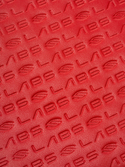 Red textured material embossed with repeating 'LABS' and leaf logo pattern.