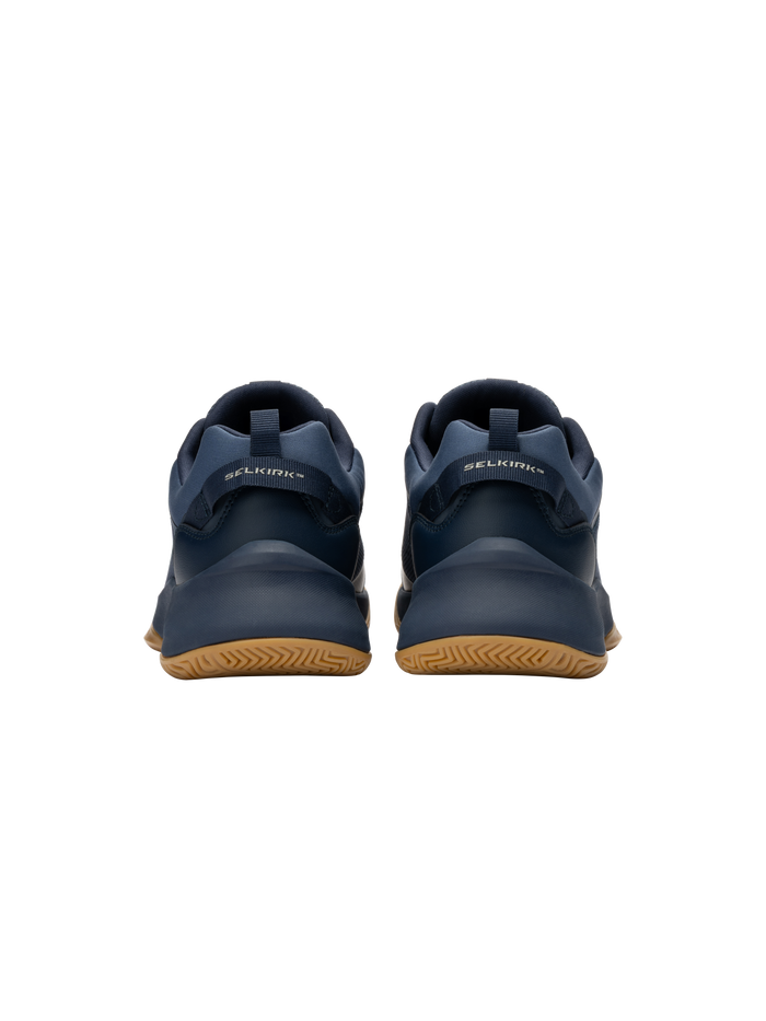 Rear view of navy SELKIRK sneakers showing heel tabs and gum rubber soles.