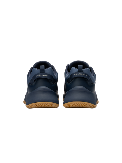 Rear view of navy SELKIRK sneakers showing heel tabs and gum rubber soles.