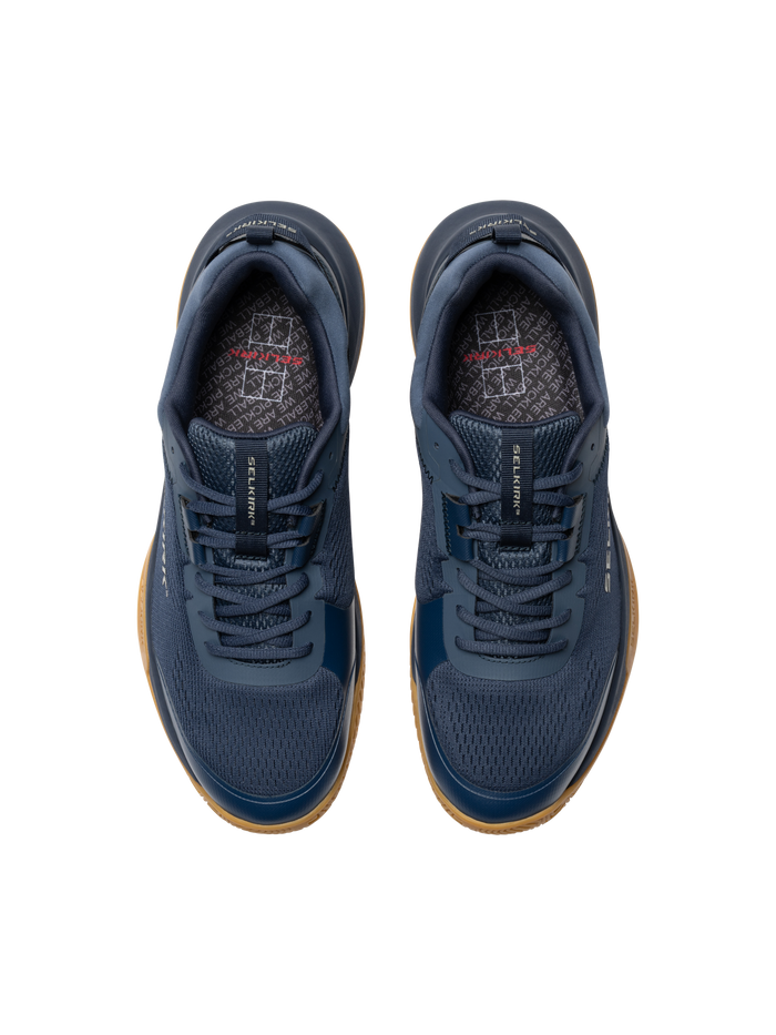 Top-down view of navy athletic sneakers with gum soles and patterned insoles.
