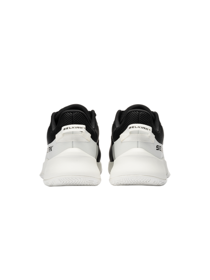 Rear view of a pair of black-and-white SELKIRK sneakers showing heel tabs with SELKIRK branding.