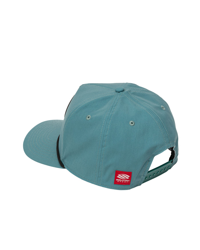Teal snapback cap, rear three-quarter view showing adjustable snap closure and small red brand tag