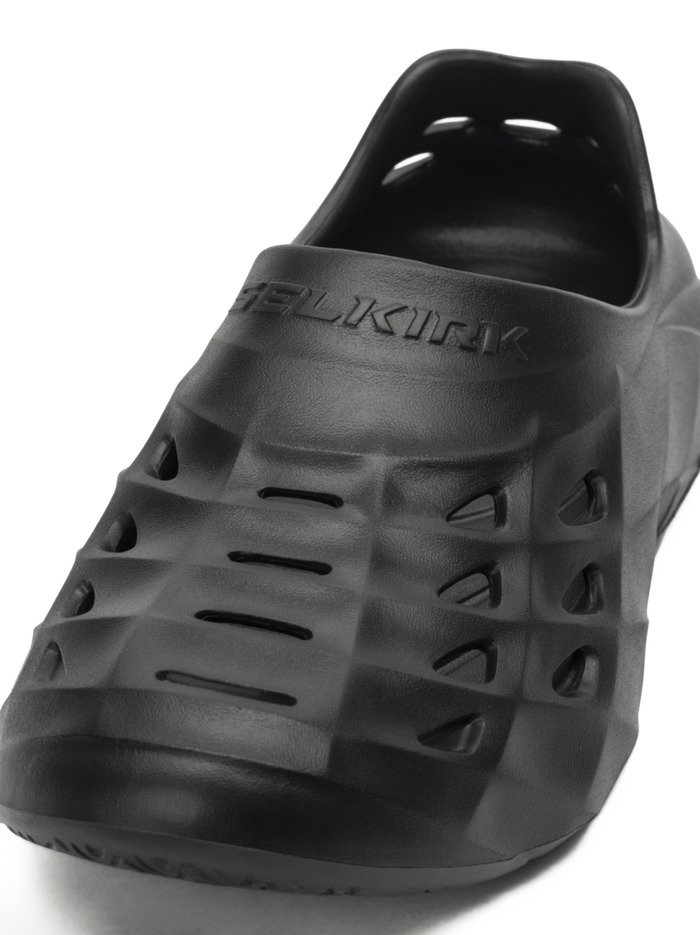 Angled front view of Selkirk Renew Recovery Shoe showing ventilated EVA upper and embossed SELKIRK logo on white background