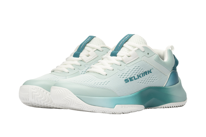 Light teal athletic court shoes with white laces and SELKIRK logo on the side