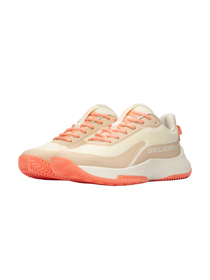 Pair of beige and cream low-profile sneakers with coral laces and soles; SELKIRK logo on the outer side.