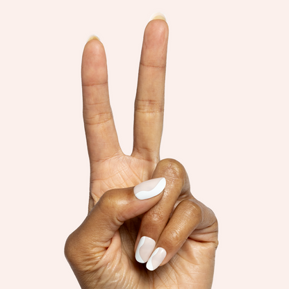 Side Swirl | Short | Round - Tab Press-On showing hand with white and neutral swirl false nails on light background