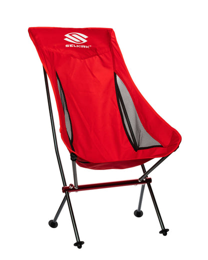 Red SELKIRK folding camping chair with mesh side panels and black aluminum frame