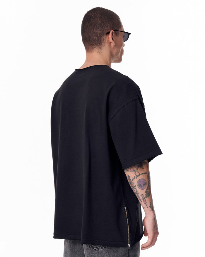 Martin Valen oversized black Sidezip T-shirt with raw-edge crew neck, rear view showing side zipper detail