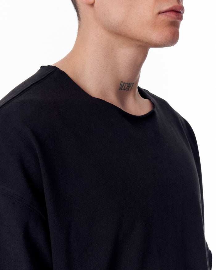 Martin Valen oversized black Sidezip T-shirt, close-up of raw-edge crew neck and upper back