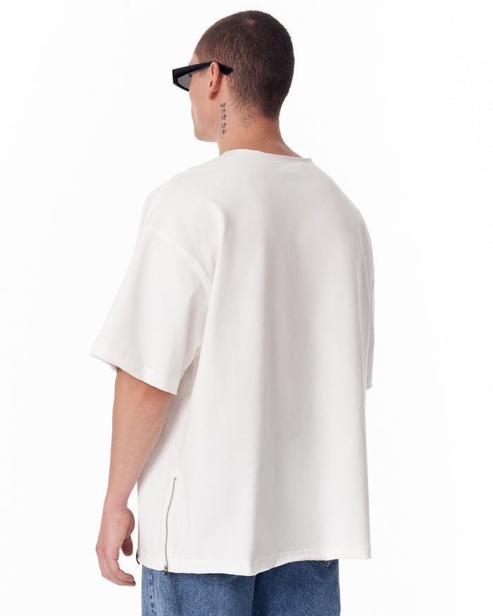 Martin Valen oversized white Sidezip T‑shirt, centered front view showing raw crew neck and model's neck tattoo