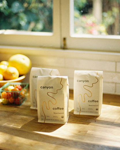 Bags of Canyon Coffee on a wood counter in Los Angeles