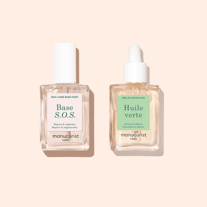 The Manucurist S.O.S Rescue Duo features two square glass bottles—Base S.O.S. with a white cap and Huile Verte with a dropper—ideal for restoring damaged nails after gel manicures.