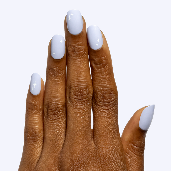 Sparkle Accent | Short | Round - Tab Press-On showing hand with light blue nails and subtle white sparkles on neutral background