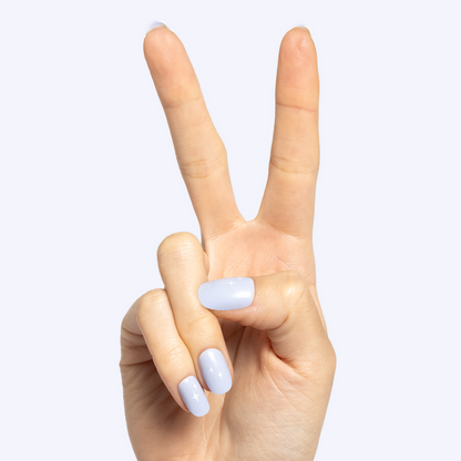 Sparkle Accent | Short | Round - Tab Press-On showing light blue false nails with subtle white sparkle details on hand against white background