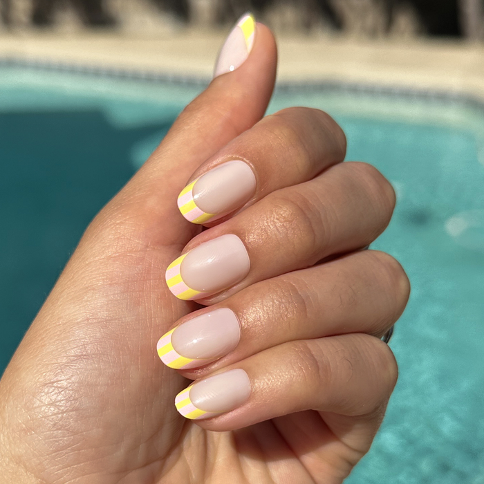 Summer Stripe French - Press-On | Short | Round milky sheer nails with vibrant citrus-striped tips for easy at-home mani