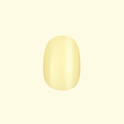 Sunny | Extra Short | Round - Tab Press-On nail in glossy pastel yellow perfect for cheerful at home manicures and easy press on wear