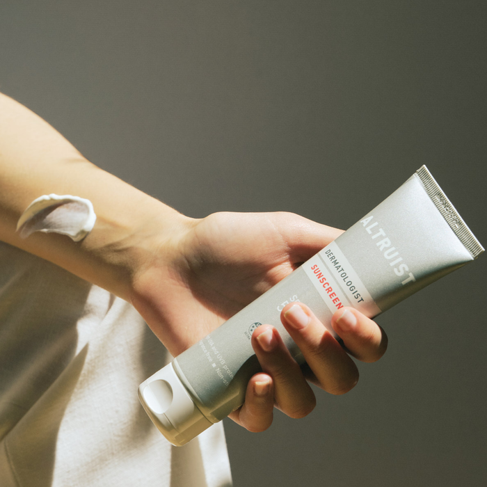 Person holding SPF50 sunscreen