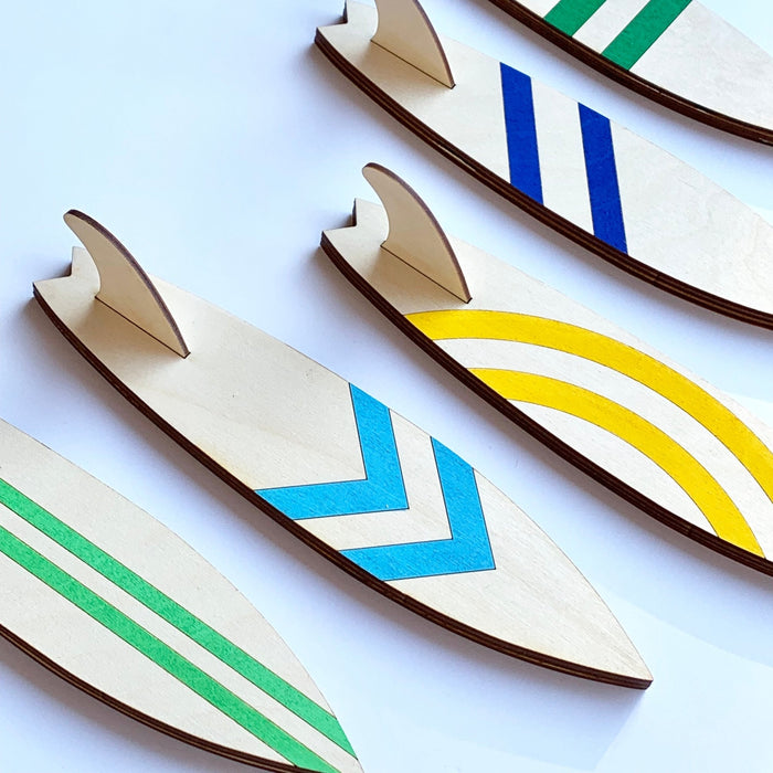 Surfboard Hooks - laser cut and laser engraved birch wood - light green vertical stripes, light blue chevron, yellow circular stripes, blue diagonal stripes, green horizontal stripes - by LeeMo Designs in Bend, Oregon