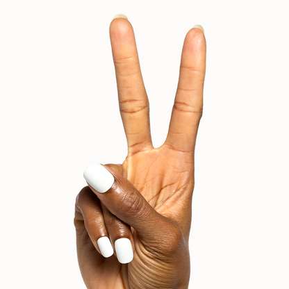 Swan | Extra Short | Squoval - Tab Press-On showing hand with crisp white false nails in peace sign pose for easy at-home mani