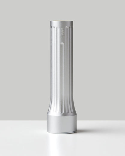 Silver flashlight with vertical ridges and flat base, cylindrical body
