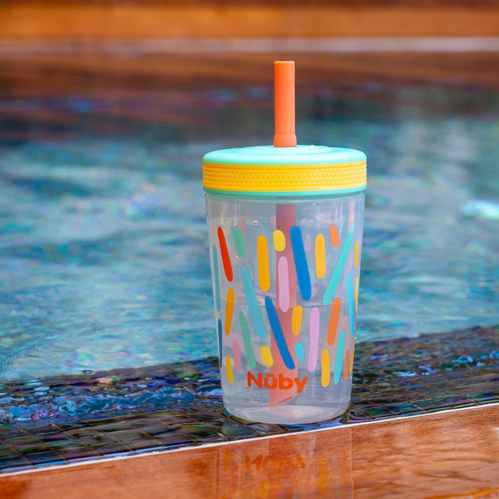 A Thirsty Kids Super Sipper Straw Cup (2 Pack) | Aqua & Yellow with a no-spill straw and lid sits on the pool edge, framed by water and pool tiles in the background.
