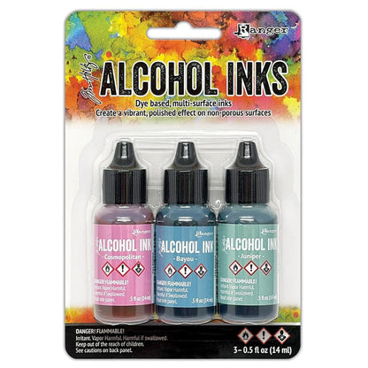 Tim Holtz - Alcohol Ink .5oz - 3/Pkg - Select from Drop Down. The alcohol inks by Ranger are dye based, multi-surface inks. They are acid free, permanent, quick drying and transparent. Available at Embellish Away located in Bowmanville Ontario. Getaway-Cosmopolitan/Bayou/Juniper