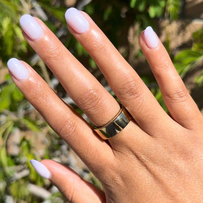 Tonal Lavender French | Extra Short | Round - Tab Press-On nails with soft lavender gradient on hand outdoors with gold ring