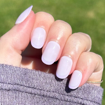 Tonal Lavender French | Extra Short | Round - Tab Press-On nails with subtle lavender French tips in natural light on hand outdoors