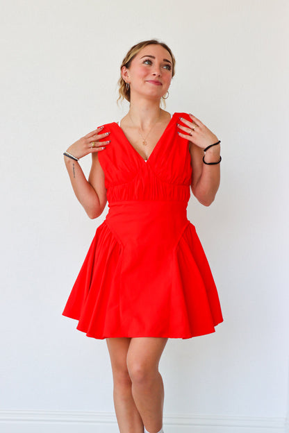 Woman wearing a red dress against a white background