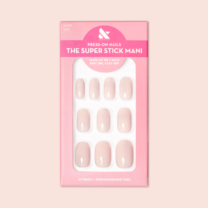 Tutu | Short | Squoval - Tab Press-On nails in soft pastel pink shade displayed in branded packaging for at-home mani.