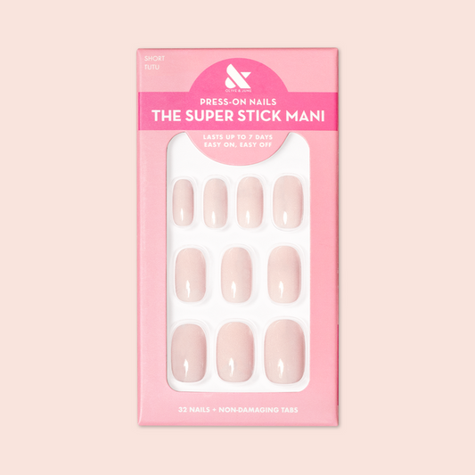 Tutu | Short | Squoval - Tab Press-On nails in soft pastel pink shade displayed in branded packaging for at-home mani.