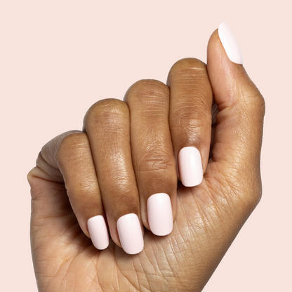 Tutu | Short | Squoval - Tab Press-On showing light pastel pink false nails on hand for easy at-home mani application