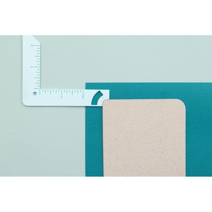 We R Memory - Book Cover Guide - Mint. Perfect book board placement, consistent gaps, trim corners at the proper angle, easily round corners and mark spot for elastic closure. It also includes a scan code for detailed instructions. Available at Embellish Away located in Bowmanville Ontario Canada.
